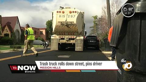 Trash truck rolls down street, pins driver