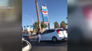 Woman bashes car window with bat during road rage incident