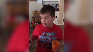 "Young Boy Challenges Himself with a Jalapeno Pepper"