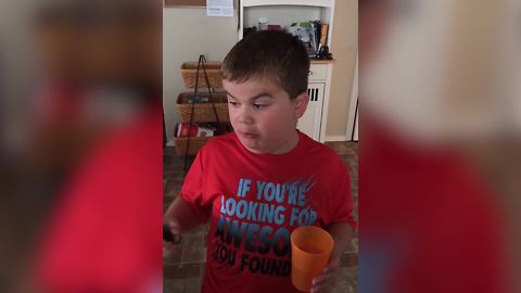 "Young Boy Challenges Himself with a Jalapeno Pepper"