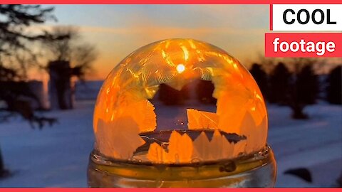 Icy conditions cause a water ball to instantly freeze in a mesmerising pattern
