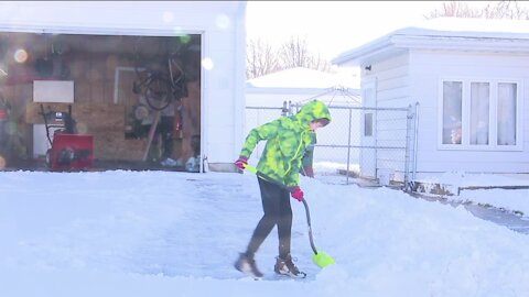 Enjoying the priceless moments: Father and son bond while shoveling snow