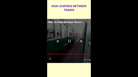 Man jumping between trains