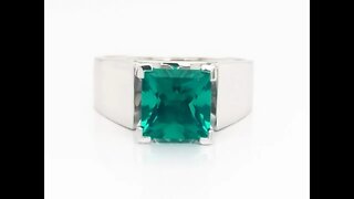 Custom white gold solitaire ring featuring a Chatham created emerald.
