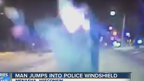 Man jumps onto windshield of police cruiser on NYE