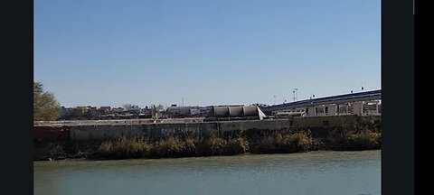 Smugglers Pull Migrants Back. Boxcars and Barbed Wire Block the Rio Grand Viewed From Mexico