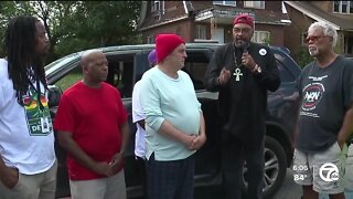 Community activists gather to protest drugs, violence in front of house where multiple people were shot