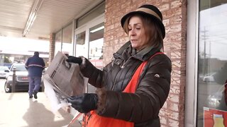 Lansing Old Newsboys hands out spoof newspapers for a good cause