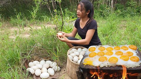 Yummy Cooking Eggs with eggplant on a stone for jungle food and eating delicious