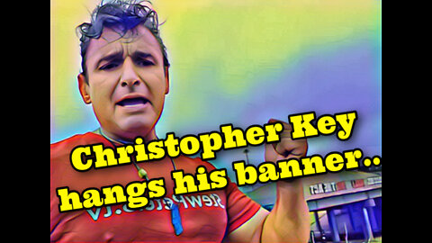 Christopher Key hangs his banner..
