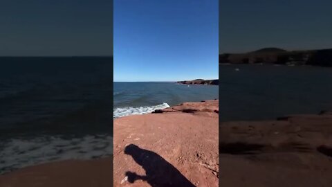 Waves, red sand, and lighthouses