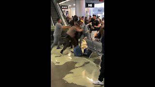 Cop Pulls Gun On Unruly Passengers At Miami Airport During Wild Brawl