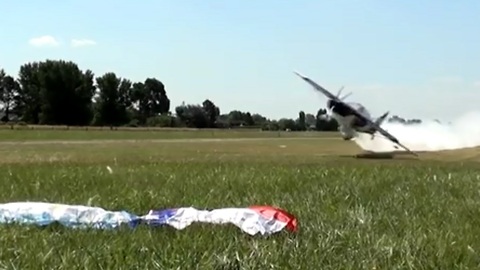Low-Flying Plane Picks Up Flags Off The Ground