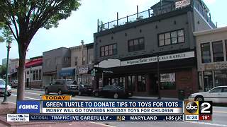 Green Turtle employees giving their tips to Tots