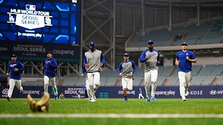 The Dodgers take the field for a workout in Seoul