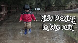 Kid Playing and splashing in the rain