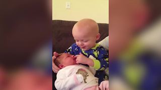 "A Tot Boy Kisses His Newborn Sister and Tries to Pick Her Nose"