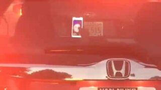 Driver in traffic is seen using Tinder