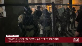 Group of protesters knock down fence at State Capitol