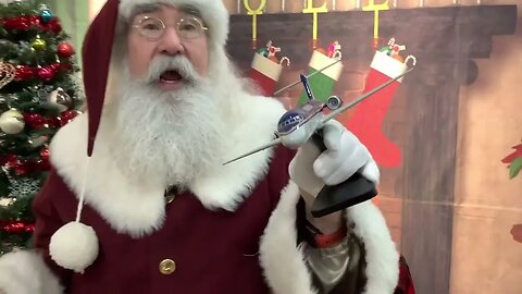 Santa talks about the new Midwest Airlines wood model replica airplane