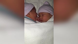 Twin Baby Chews Sister’s Hand While Sleeping