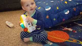 Precious baby hugs his toy airplane