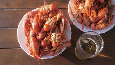 Crayfish cook in water with spices and herbs. Hot Boiled Crawfish. Lobster closeup. Top view