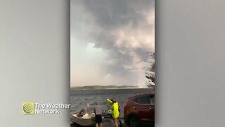 Boaters pack up as storm clouds and waterspout form over lake