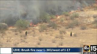 Air15 over a brush fire near the Loop 303 and I-17