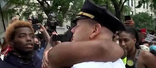 One of NYPD's top cops takes a knee and hugs protesters
