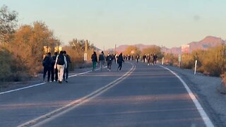 Masses of illegal immigrants walking down the highway in and out of Lukeville, AZ