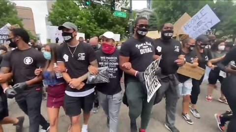 'If you ain't with us, you against us:' Broncos players join protests, lead march through Denver