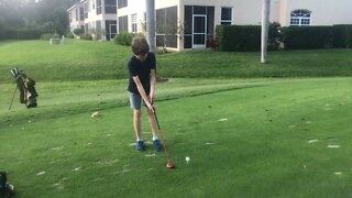 Kid playing golf in Florida