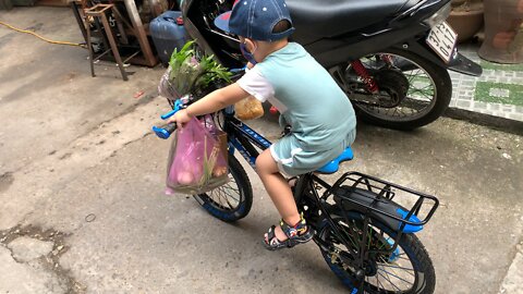 Baby goes to buy food by bicycle