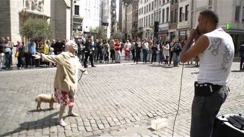 Elderly woman dances along to beatboxer in Brussels square