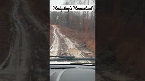 driving on a muddy road in a little Ford escape