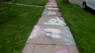 Samantha Nesbitt and her daughter Alexis drew cartoon characters on the sidewalk outside of their Lansing home on Wednesday and Thursday.