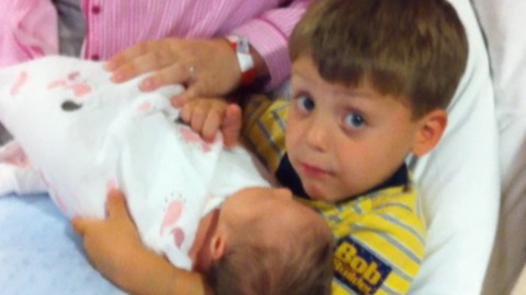 Little Boy Shushes His Dad While His Baby Sister Sleeps