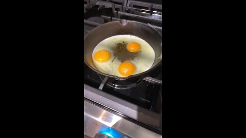 Frying eggs on pan with olive oil