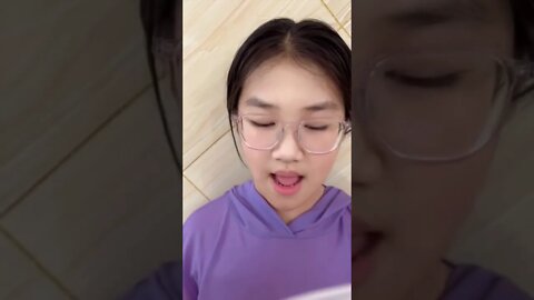 Young Chinese Girl Reads A Story About Apples And Oranges