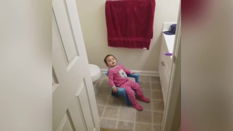 Baby Girl Loves Sitting In The Bathroom
