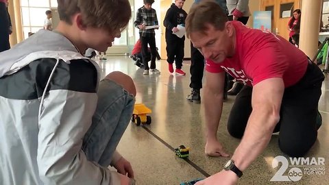 Students learn how to code and program robotic cars for World Math Day