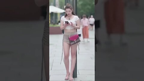 Beautiful Chinese Girl Standing On The Street Waiting To Be Picked Up