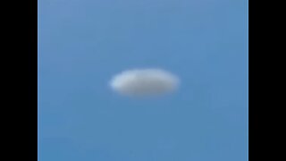 White Disc UFO Filmed from Plane over Denver