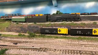 N Scale BLI 4-4-4-4 pulling a passage train over a bridge