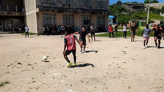 U.S. Sailors, Marines and Colombian Sailors play soccer with students