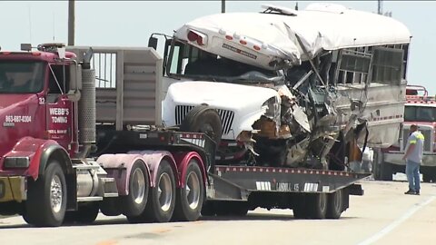Crash between semi-tanker truck and bus leaves 1 dead, 10 hospitalized
