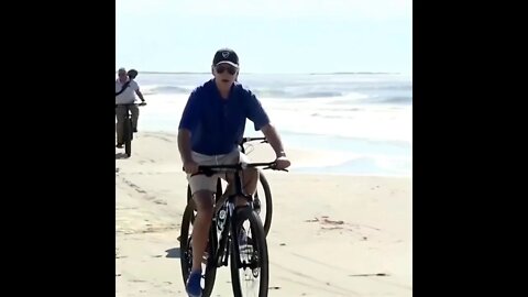 Joe rides his bike on the beach