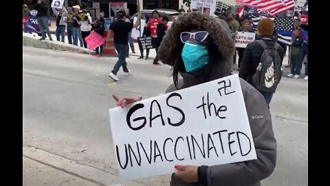 Crazed Woman Outside AOC's Rally In Texas Holds Sign Reading "Gas The Unvaxxed"
