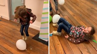 Kid Wipes Out After Tying To Jump On Balloon